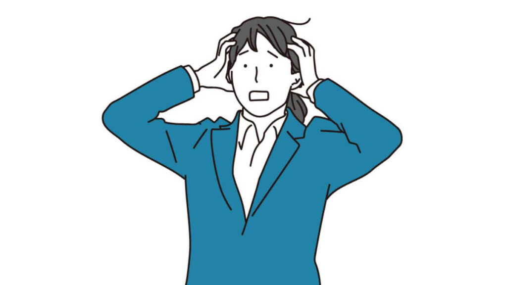 両手を頭に当て困った表情をするキャリアウーマン