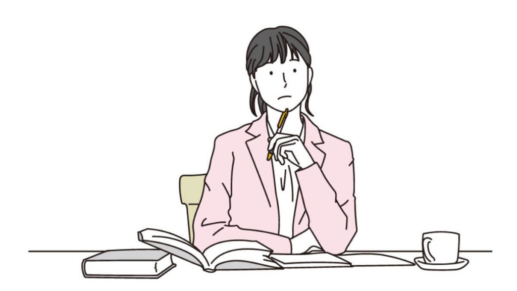 ペンを持ち考えるキャリアウーマン