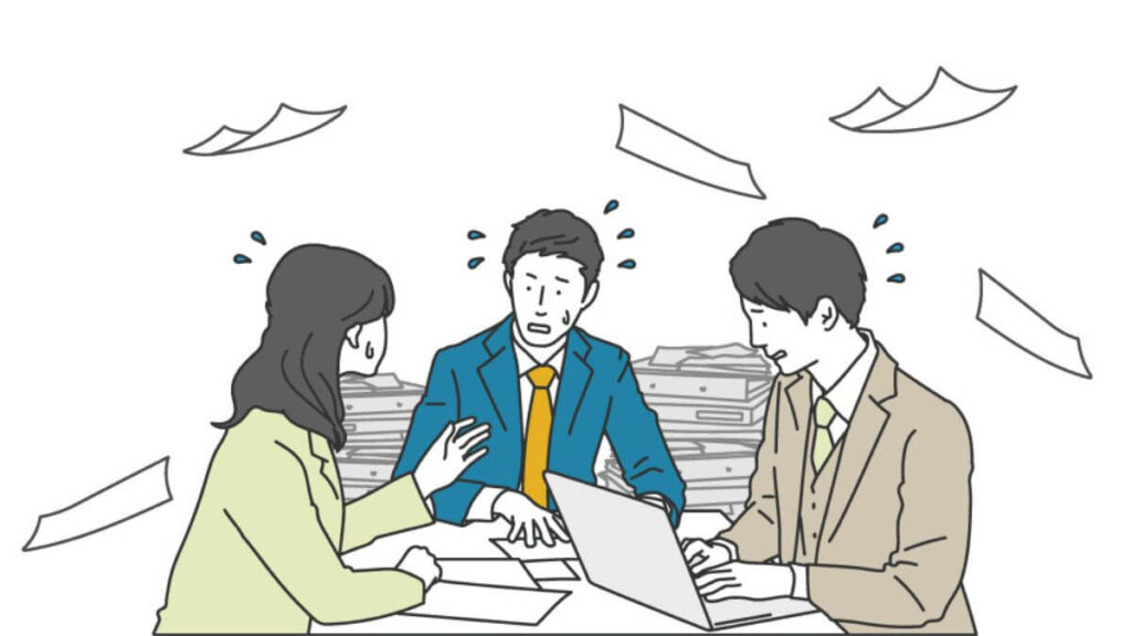焦りながら仕事をするサラリーマンとキャリアウーマン