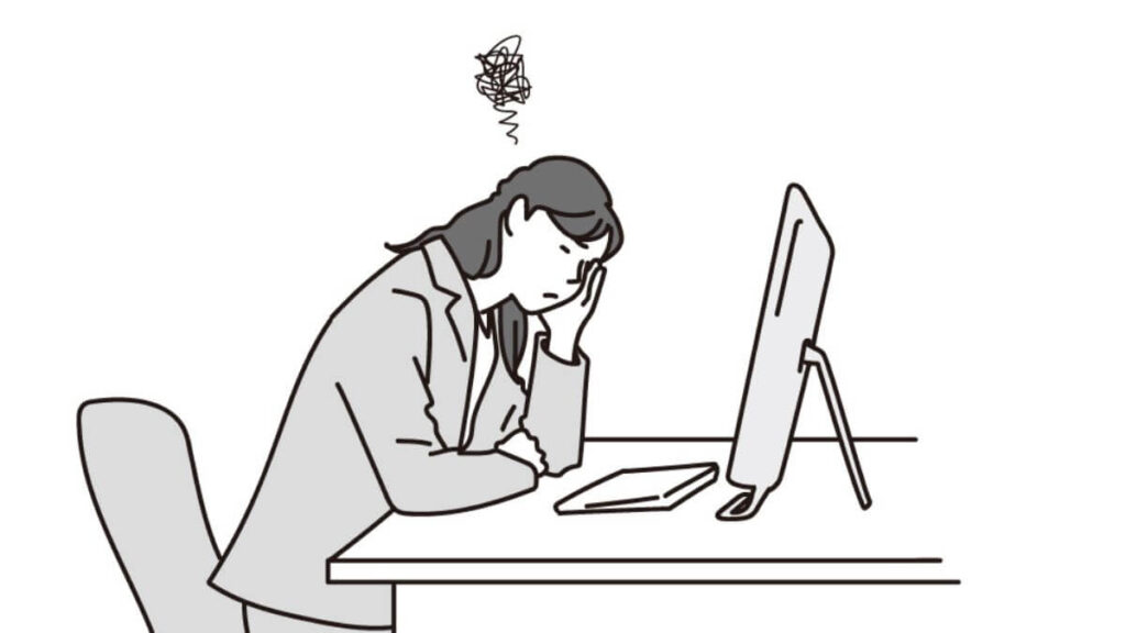 パソコンの前でつらそうな表情をするキャリアウーマン