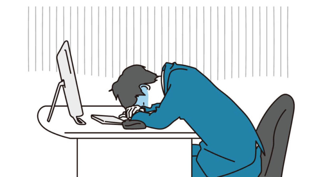 机に伏せて落ち込むサラリーマン