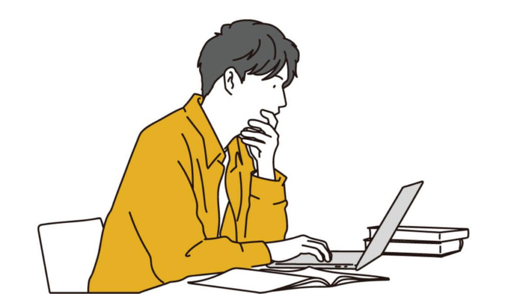 自宅でパソコン作業をする若い男性