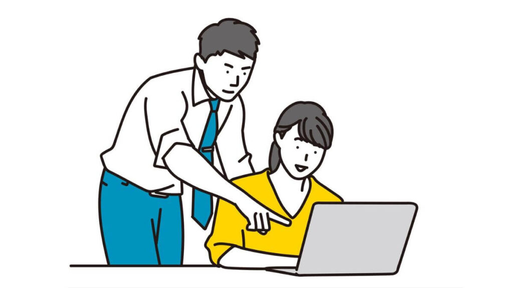 部下に仕事を教えるサラリーマン