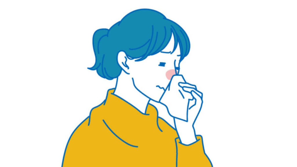 鼻水をティッシュでかむ若い女性