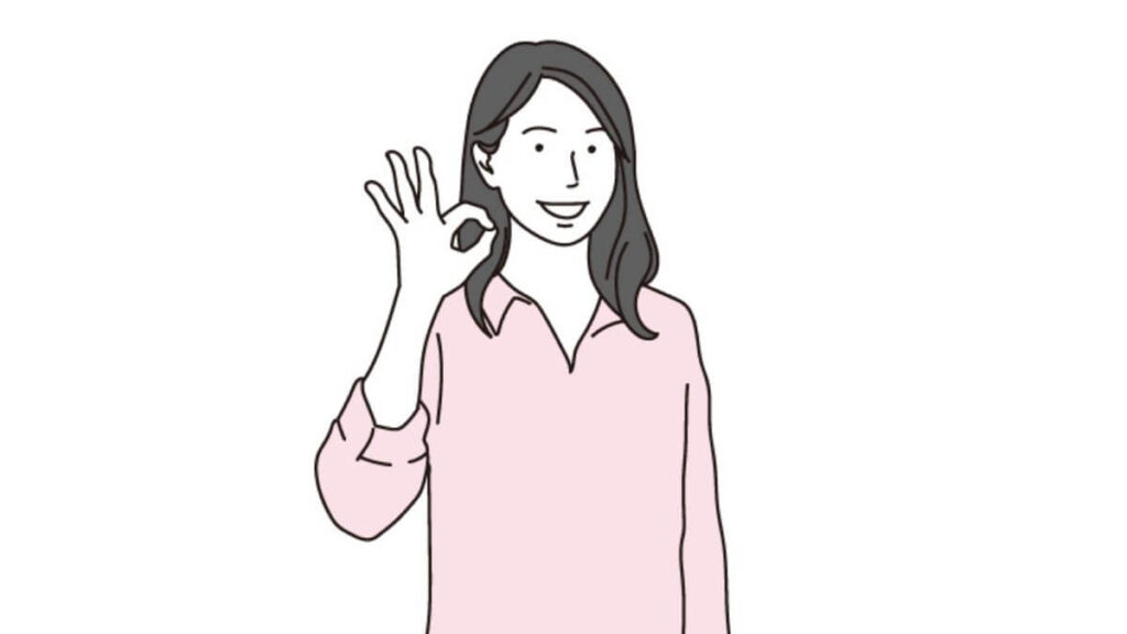 笑顔でOKサインを出す若い女性