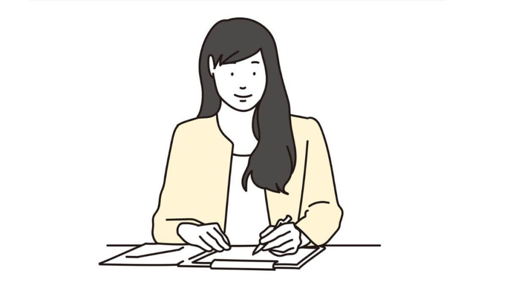 メモを書くキャリアウーマン